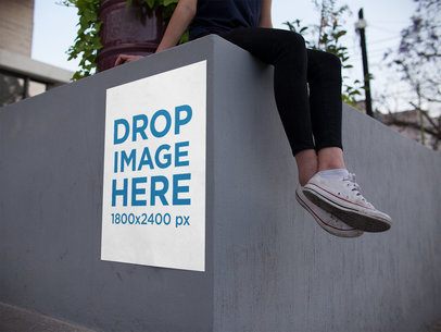 Poster on a Concrete Urban Structure with a Woman on Top of It Mockup
