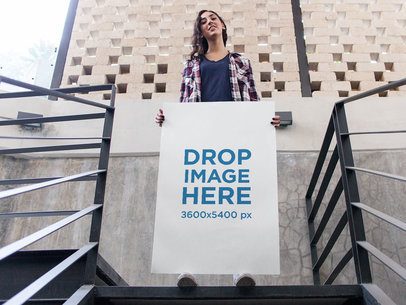 Pretty Woman Holding a Big Poster While in Stairways in the City Mockup