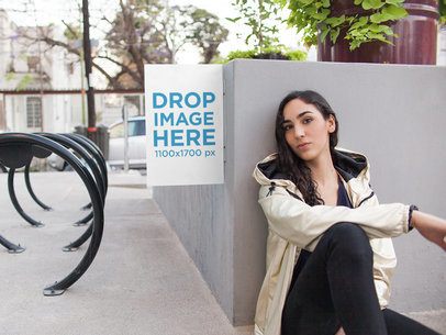 Small Wall Poster With Woman Sitting Next to it Mockup