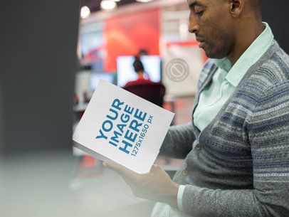 Serious Man Reading a Book While at the Office Mockup