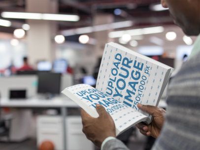 Mockup of an Opened Book Being Held by a Black Man a14502
