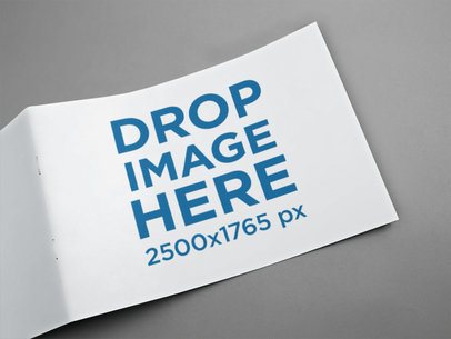 Front Part of Catalogue Lying Open Over a Gray Surface Mockup a14588