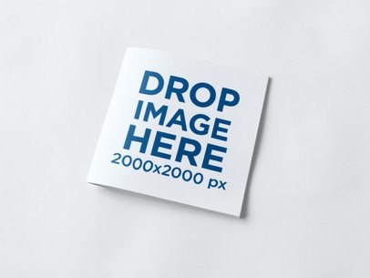 Square Booklet Lying Over a White Surface Mockup
