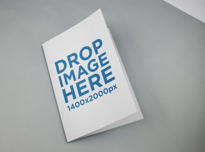 Cover of a Open Catalog Lying on a Grey Surface Mockup a14590