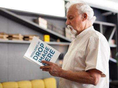 Senior Guy Reading a Book While Standing in a Hotel Lobby Mockup