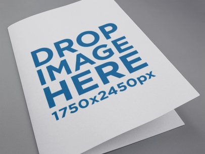 Close Up Mockup of a Catalog Lying on a Grey Surface a14598