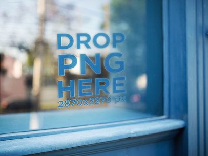 Decal Near the Corner of a Window Surrounded by a Wooden Blue Frame Mockup a14422