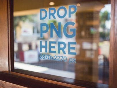 Angled Mockup of a Window Decal Surrounded by a Brown Wooden Frame a14420