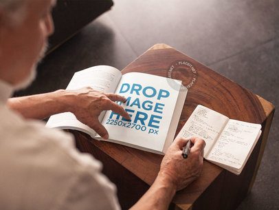 Over Shoulder Template of a Senior Man Taking Notes from his Lectures While Sitting Down