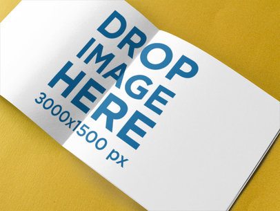 Open Booklet on a Yellow Surface Mockup