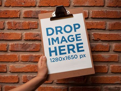 Booklet Held Against a Bricks Wall Template a14630