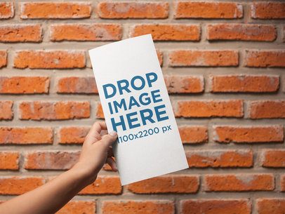 Template of a Vertical Booklet Held Near a Bricks Wall