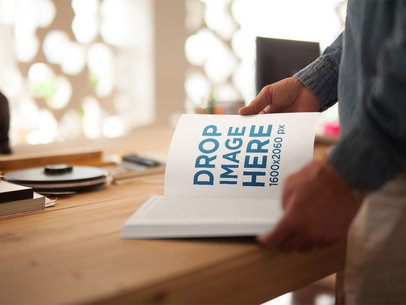 Book Being Read by a Guy While at a Wooden Desk Mockup