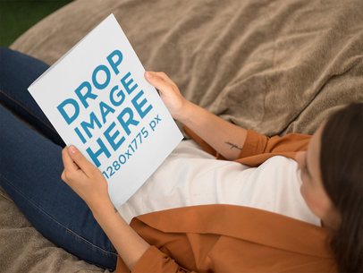Young Woman Looking at a Catalog While Lying Down Mockup