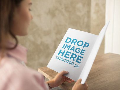 Mockup of a Pretty Girl Reading a Catalog While at the Office a14645