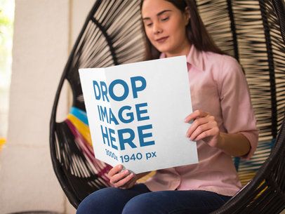 Booklet Mockup of a Pretty Girl Reading a Catalog While Sitting Down on an Acapulco Chair a14643