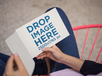 Template of a Catalog Held by a Woman While Sitting on a Pink Chair