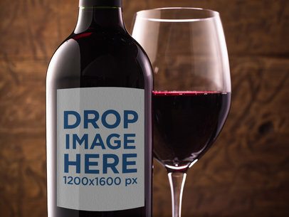 Closeup of a Red Wine Bottle Mockup With a Served Glass