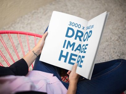 Catalog Template Being Read by a Woman While Sitting Down on a Pink Acapulco Chair