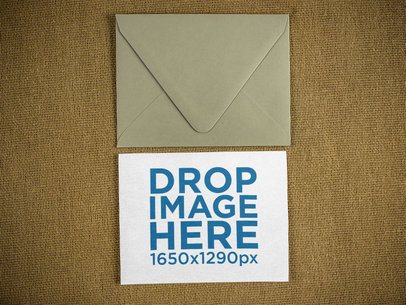 Invitation Lying on a Table With Envelope Above It 