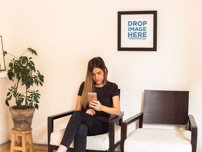 Template of a Framed Art Print on a White Wall of a Waiting Room With a Woman