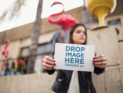 Half Letter Flyer Mockup Held by a Woman With a Flamingo on the Back