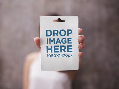 Gift Card Mockup Held by a Woman Against a Blurred Background
