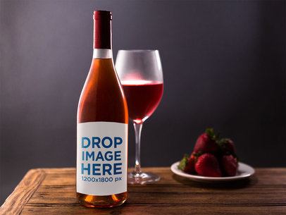 Rose Wine Bottle Template With a Served Glass and Strawberries on a Wooden Table
