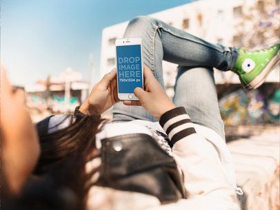 Mockup of a Girl Using her White iPhone 6 While Having a Break at the Skatepark a14703