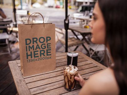 Paper Bag Template Lying on a Cafe Wooden Table While a Girl is Waiting for her Friends a14742