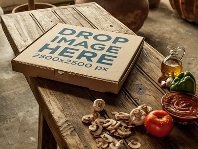 Template of a Pizza Box Beside Ingredients on a Wooden Table