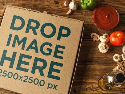 Template From Above of a Pizza Box on a Wooden Surface With Ingredients Nearby