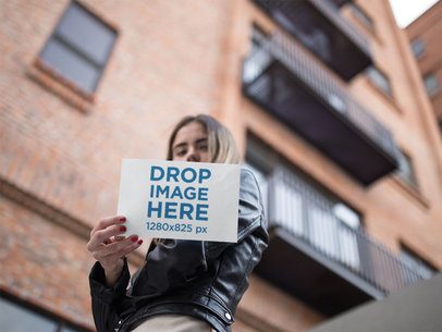 Template From Below of a Woman Holding a Horizontal Flyer in the City