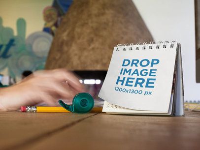 Calendar Mockup Lying on a Wooden Desktop
