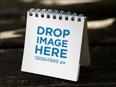 Small Calendar Template Standing on a Dark Wooden Surface