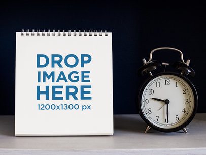 Calendar Template Standing on a White Surface Near a Vintage Clock Against a Black Background