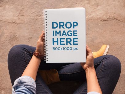 Top View Mockup of a Spiral Notebook Held by a Woman