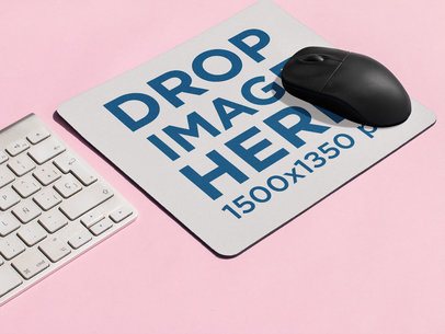 Mousepad Mockup Lying on a Pink Surface with a Black Mouse on it and a Keyboard