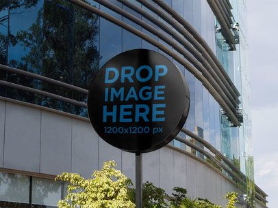 Round Sign Mockup Standing Outside a Big Mall