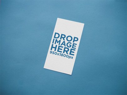 Vertical Business Card Mockup on a Blue Surface