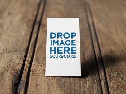 Vertical Business Card Mockup Standing on a Wooden Surface