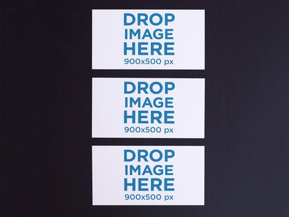 Mockup of Three Business Cards Mockup Lying on a Black Surface
