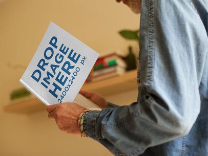 Man Reading a Square Book Template While Indoors