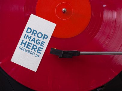 Vertical Business Card Mockup Lying on a Red Vinyl LP a15024