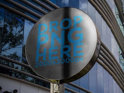 Round Sign Mockup Standing in a Coffee Shop Outside a Mall