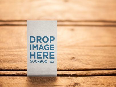 Vertical Business Card Template Standing on a Wooden Surface