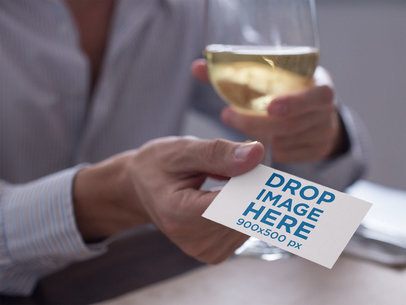 Man Handing a Business Card Mockup While Drinking White Wine a15033