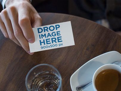 Man Showing a Business Card Template While at the Cafe a15005