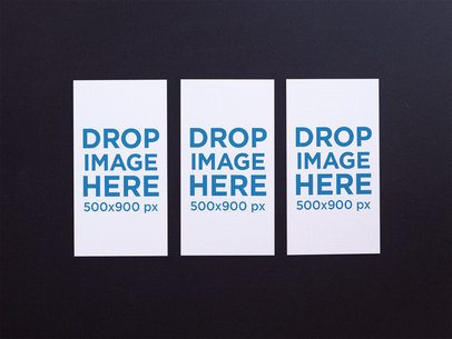 Three Vertical Business Cards Mockup Lying on a Black Surface