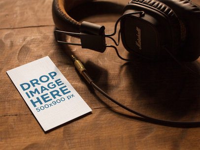 Vertical Business Card Template Lying on a Wooden Table Next to Headphones